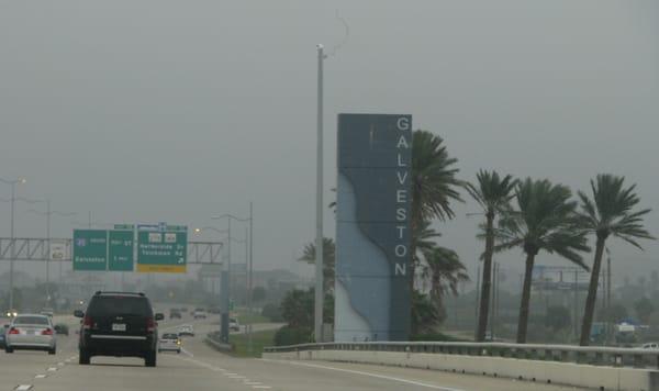Over the causeway is this entrance marker to Galveston - cruise port, historic district and homes, ornate buildings, beach, and the Seawall