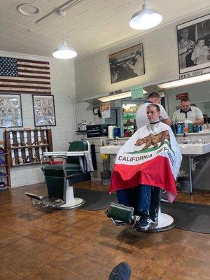 Barber and client on cutting floor