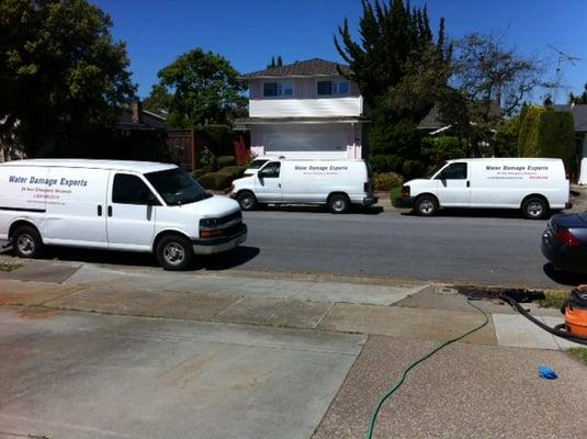 3 Company vans on a job site