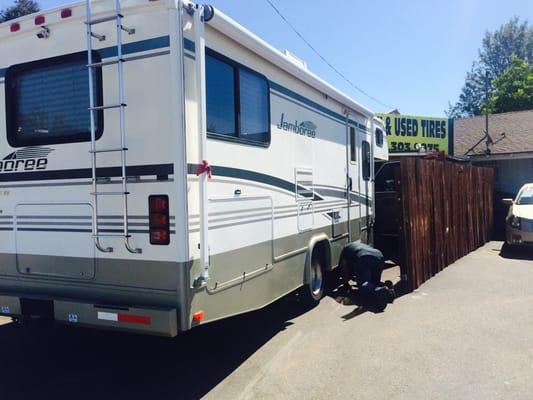 Jorge placing the jack under the RV to fix the tire. We love him!!!