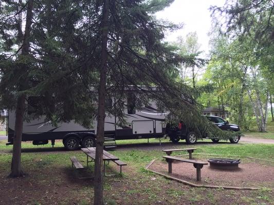 Beautiful campsite with a fire ring, bench, table, & plenty of trees!