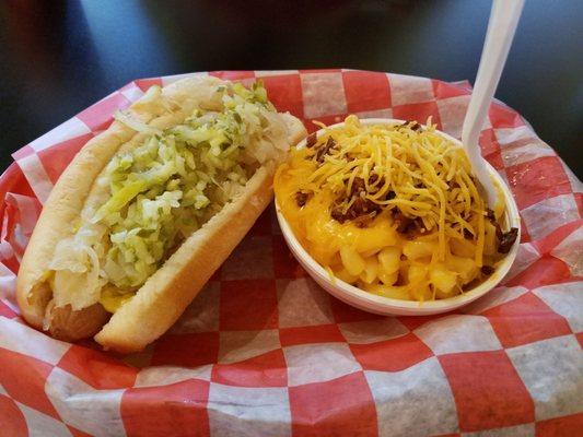 Hot dog with sauerkraut, mustard and pickles with mac & cheese