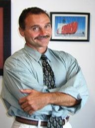 Martin in his office with his former ship, Coast Guard Cutter Polar Star in background.