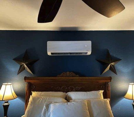 Ductless Mini Split Evaporator installed and centered inside of a bedroom