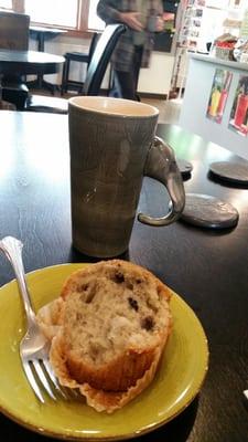 Blueberry muffin and a latte in a pretty mug.