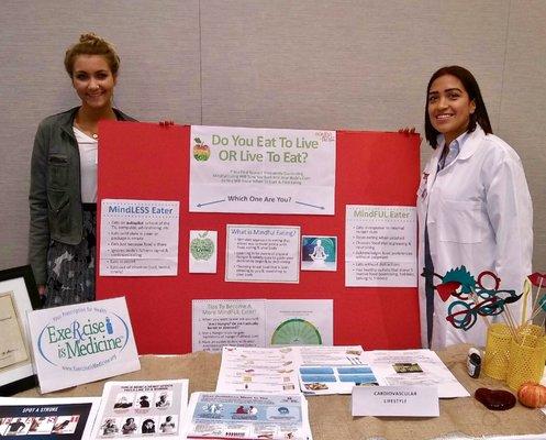 Nicolette displaying her poster on mindful eating at a nutrition conference