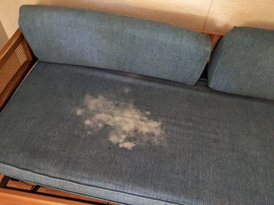 stained sofa in motel room