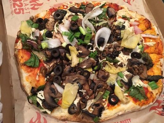 Vegan cheese pizza with mushrooms, olives, & artichoke hearts galore
