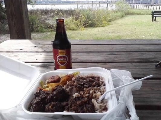 Oxtails, rice & beans, cabbage & plantain, with malt soda. (Photo taken at nearby boat landing.)