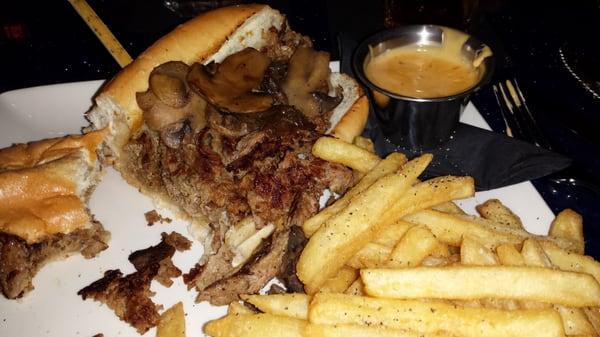 Philly Cheesesteak - shaved Ribeye, provolone, mushrooms, fries, side of cheese sauce. Also comes w/ peppers & onions.