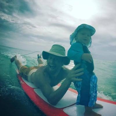 Founder of Sun-Sessions..com, Bruce Bailey, giving his own son his very first experience riding a wave. Who looks happier?