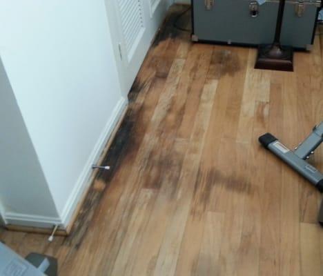 Water damaged floors from repeated flooding due to leaks in hot water heater and AC.