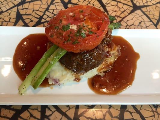 Amazingly delicious 24-hour braised short rib over red skin mashed potatoes with asparagus, topped with A roasted tomato. Yum!