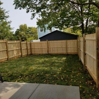 Privacy fencing installed with sod and ground grading