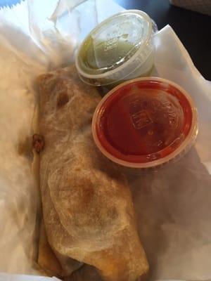 Burrito and salsas after removing the foil wrapping