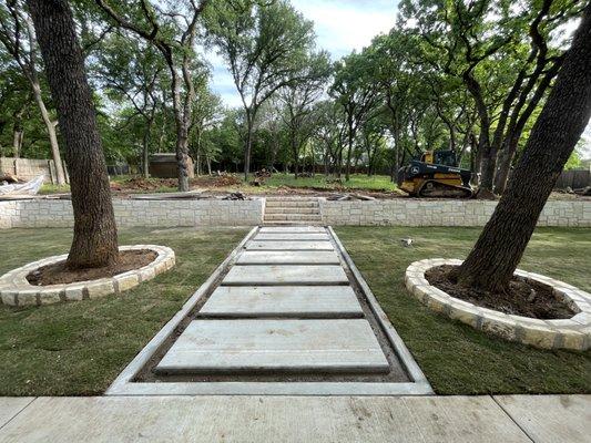 Client received new concrete steps leading up to his Austin white steps and retaining wall as well as new St.Augustine sod.