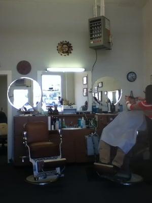 Two barber's chairs and a couch and chairs for waiting customers. Right between the music shop and La Fornaretta.