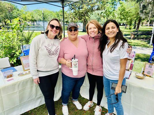 Isla Mae Board Members at Wellness Festival sharing their mission. Rediscover Beauty Through Community