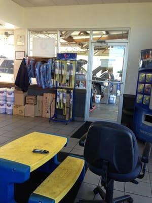 Waiting area not that clean old furniture.