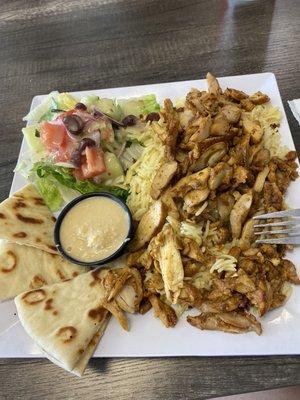 Chicken shawarma plate! Chicken over rice, pita and hummus and fresh salad. I did opt for no feta so they put some dressing.