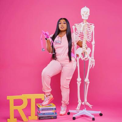 "Radiant X-ray professional exudes confidence in stylish peach jogger scrubs set - a perfect blend of comfort and fashion."