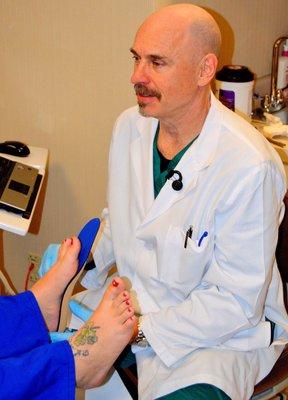 Dr. McLean performs a thorough exam to properly fit a pair of custom foot orthotics