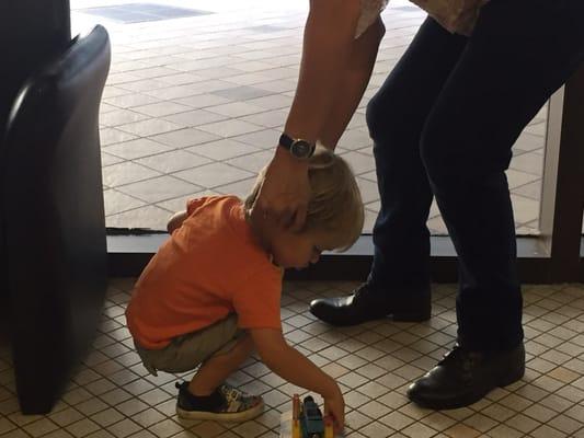 Perfecting the cut off the chair while he is distracted, I mean busy, playing trucks.