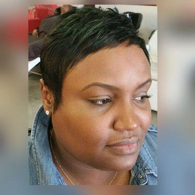 Short pixie cut with a hint of green highlights in the crown of her hair