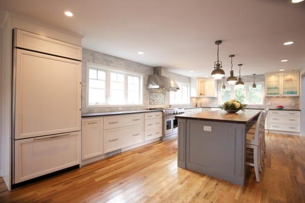 Shaker Style Kitchen Cabinets with Quartz countertop and Dark Walnut island top. Marble tile backsplash.