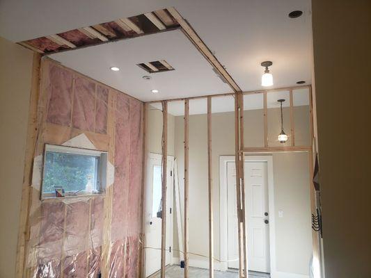 A newly framed wall and patches before blueboard installation