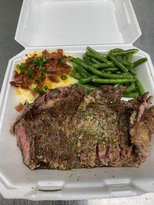 Juicy Ribeye served with loaded golden garlicky mashed potatoes and seasoned green beans