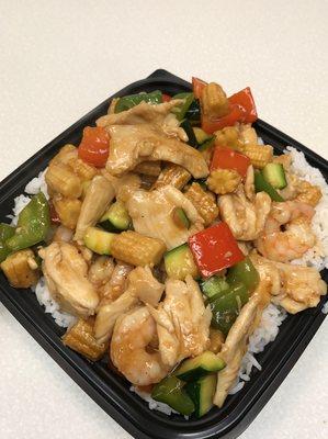 Large chicken and shrimp bowl with mixed peppers, baby corn, and zucchini. Tokyo sauce