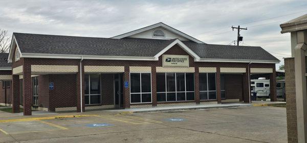 Front of post office. No hours for front desk help.