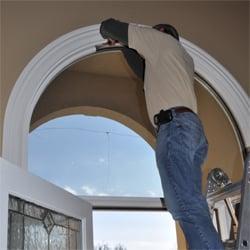 Wood trim is detached carefully, so that the cracked glass unit can be removed.
