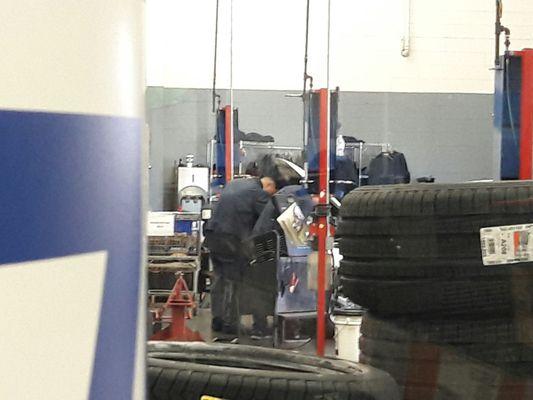 Two workers replacing a battery.