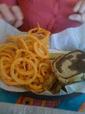 Fish Ruben with onion rings.