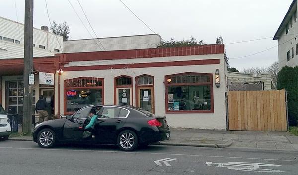 Outside of barber shop on east side of 32nd Ave NW near NW 65th St.