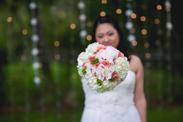 Happy bride with LED light curtain behind her.