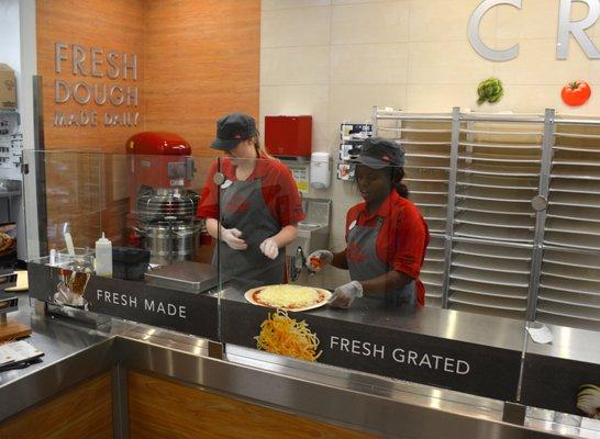 Sauced and now cheese is added followed by pepperoni