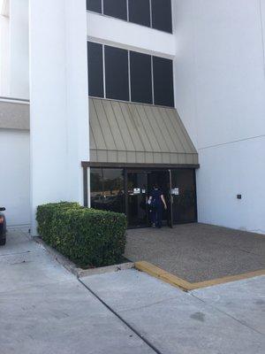 The entrance is around the back side of the building