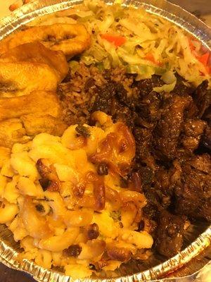 Oxtail Dinner: $11 sweet plantains, peas $ rice, steamed cabbage with a side of mac & cheese. Big portions very tasty.