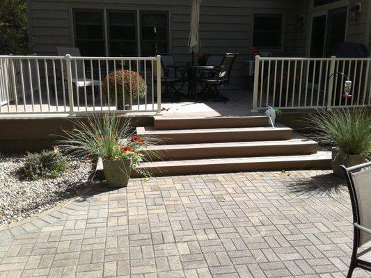 beautiful custom deck we did with a half hexagon open stair case