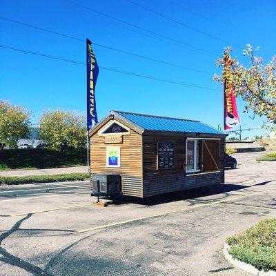 New coffee kiosk on south academy in the parking lot of crunch fitness.