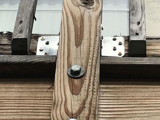 L brackets with screws in every which way but straight and flush.