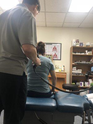 Doctor fixing key pressure points on my wife's upper and lower back