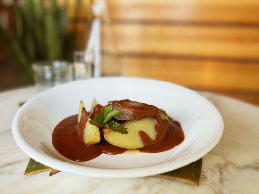 Agave roasted lamb shank with homemade mole negro and roasted potatoes