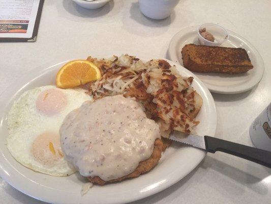 Chicken Fried Steak, over easy eggs, 1/2 hash browns 1/2 home fries, and grilled sweet potato bread!