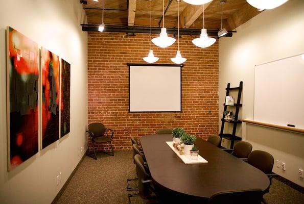 The Transformation Room features a projector/screen, mounted whiteboard and seating for up to 10 people.