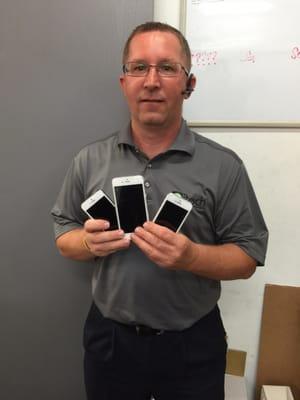Brad repairing a few phones.