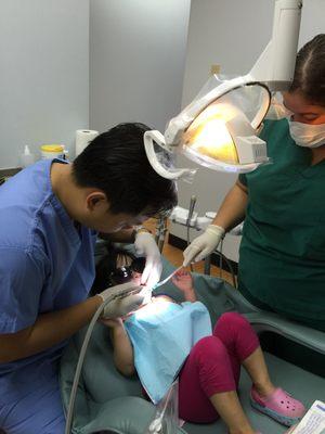 Doctor cleaning Abigail teeth